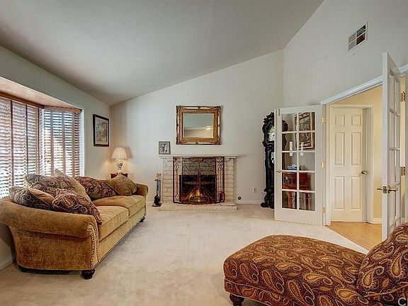 Large bay window allows lots of light or darken room with 2" wood blinds. Cozy wood-burning fireplace and mantel for family photos. Vaulted ceilings adds dimension to this lovely room.