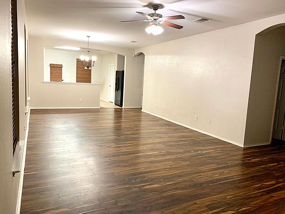 View of open floor plan - living and dining room area, and into kitchen.