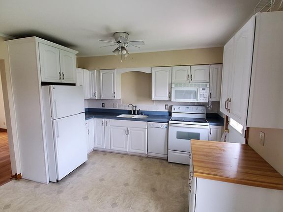 Kitchen- Electric range, microwave/hood, dishwasher, refrigerator and twin sink with disposal.
