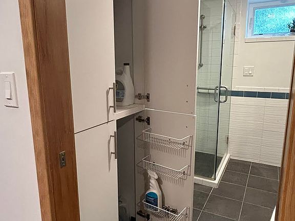 Bath storage closet; walk in shower behind