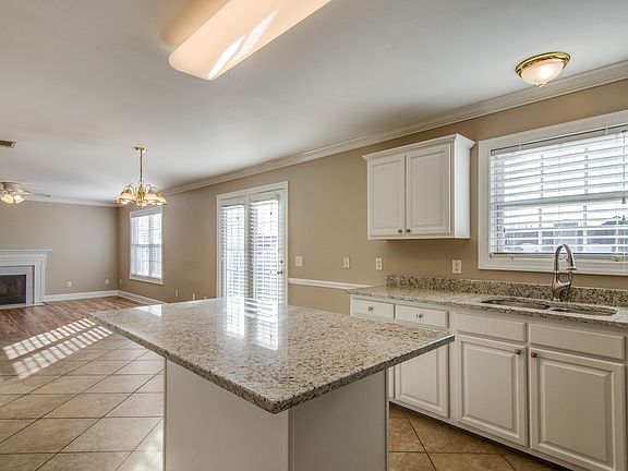 Kitchen opens to family room with fireplace