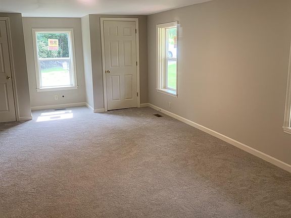 Living room has 2 closets for storage or extra clothing
