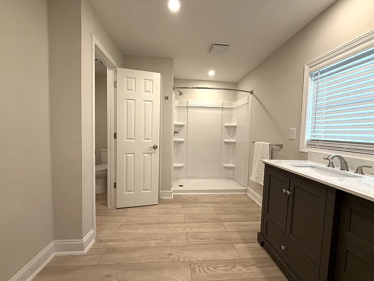 Primary Bathroom with separate toilet room, linen closet, walk-in closet