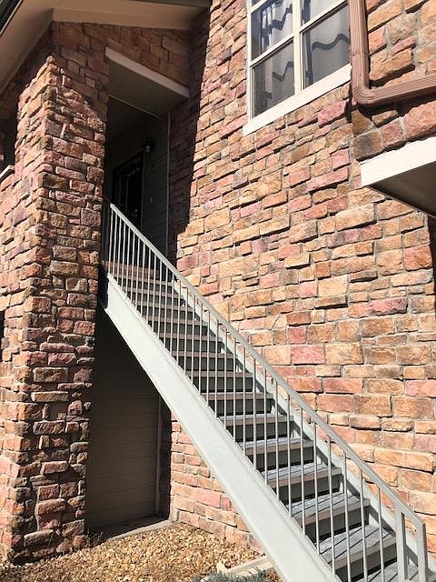 Entrance with stairway in front of the garage,with stone accent.