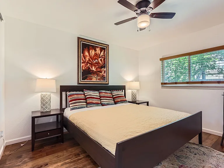 Primary bedroom with king-sized bed and attached bathroom.