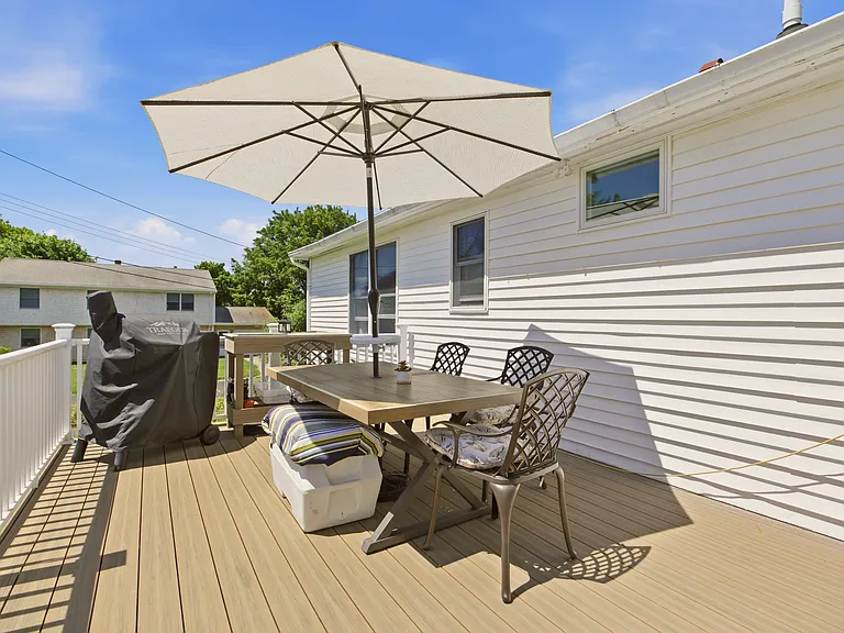 Back deck is newly remodeled with lighting, seating, storage, traeger grill, high top table.