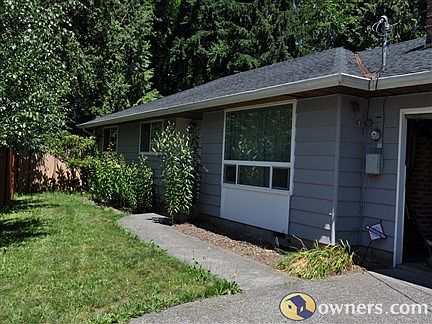 Front entrance & driveway to 1151 sq ft home on 15,000 sq ft lot
