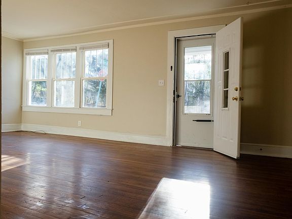 Large living room with original hardwood floors. Fresh Edgecomb Grey paint.
