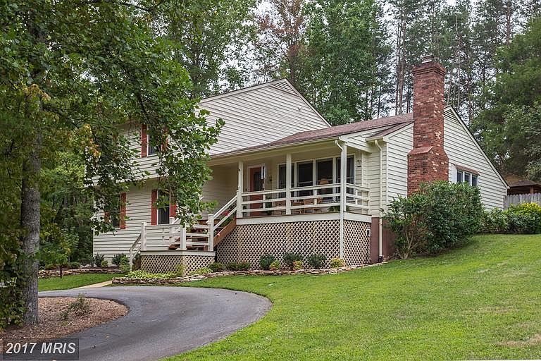Front of home with circular driveway, 2-car garage