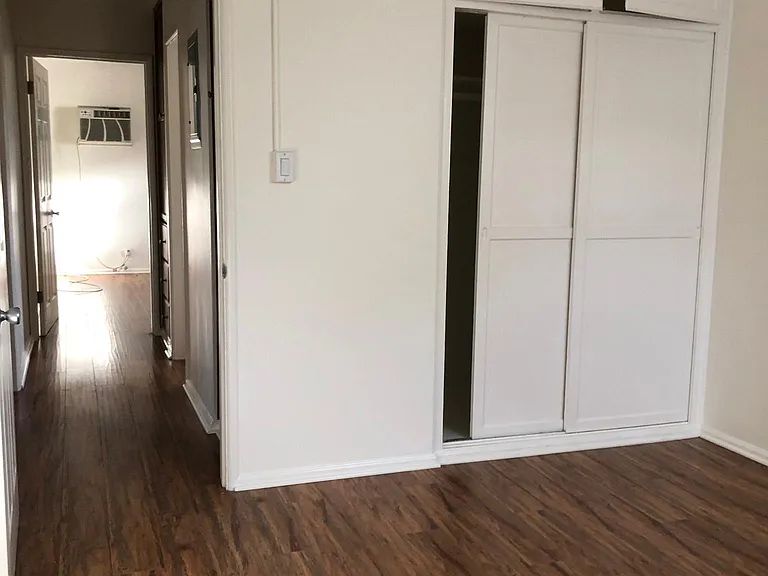 Hall leads to bedrooms on opposite sides of the bathroom