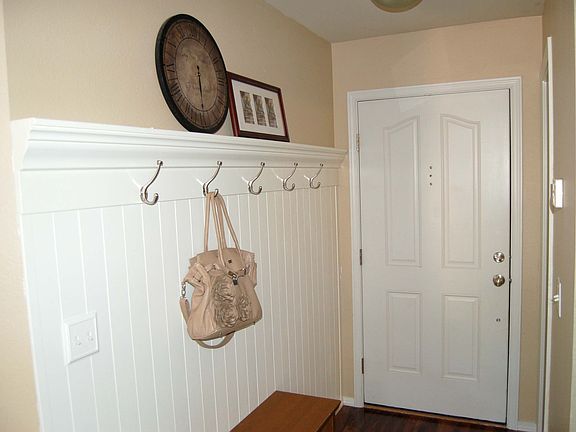 An Inviting Entry with Coat Hooks and Wainscoating 