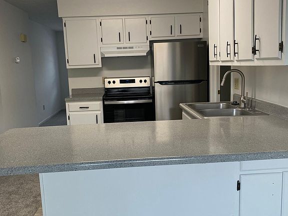 Kitchen with new stainless steel appliances, updated countertops.