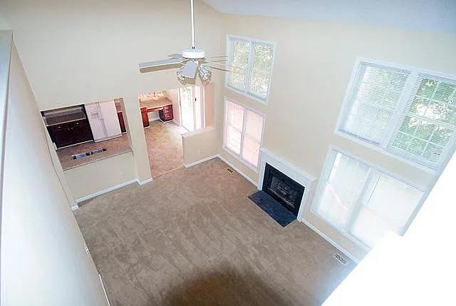 Living room with beautiful bright windows and views. Gas log fireplace. White appliances have been updated to SS. See other pics.