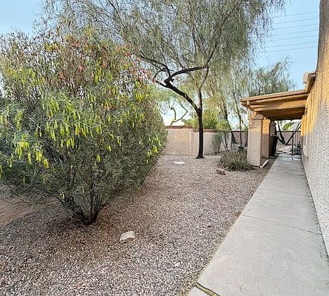 Sideway of property with a private garden