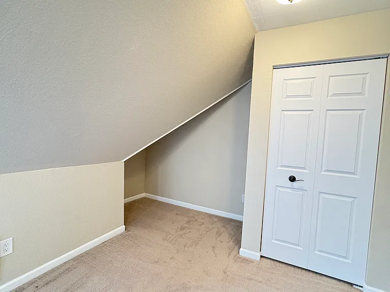 The second bedroom holds a cozy space perfect for creating a reading nook for kids and adults alike.