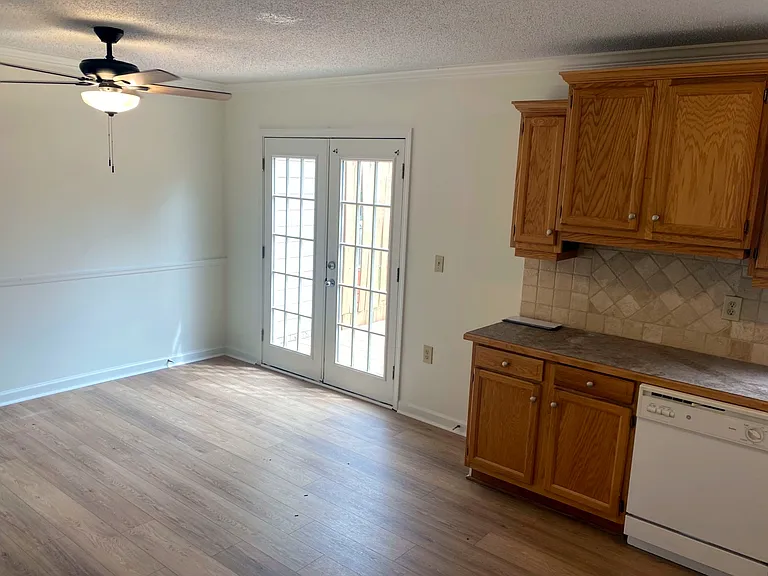 Dine in kitchen with sunny french doors to the new deck. Mornings and dinners in the natural light make every meal a pleasant experience.