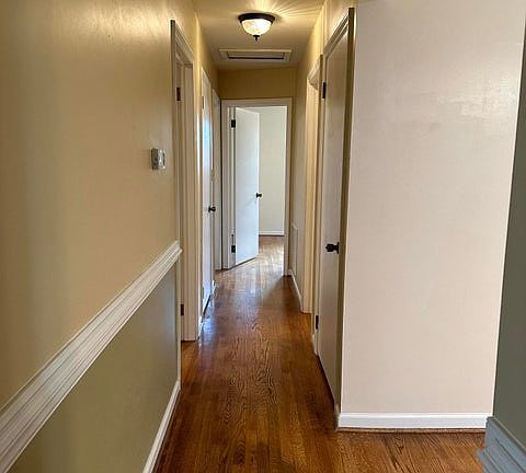 Hallway to 3 bedrooms and bathroom