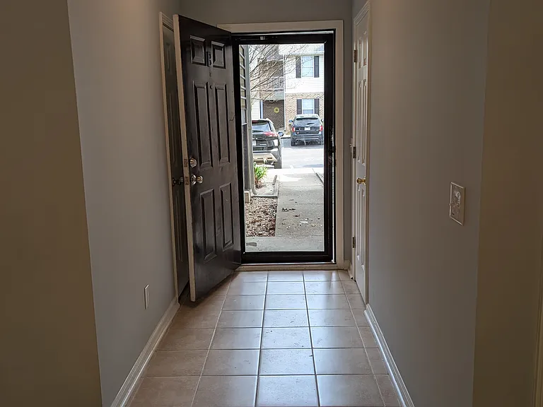 Entrance hallway with coat closet and additional storage room