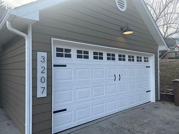 LED modern farmhouse light above garage and new garage door fixtures.