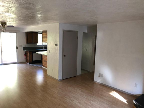 Entering into main living & dining area. Fireplace is in corner to the right. Hall with bedrooms to the right of kitchen. Deck of sliding doors.