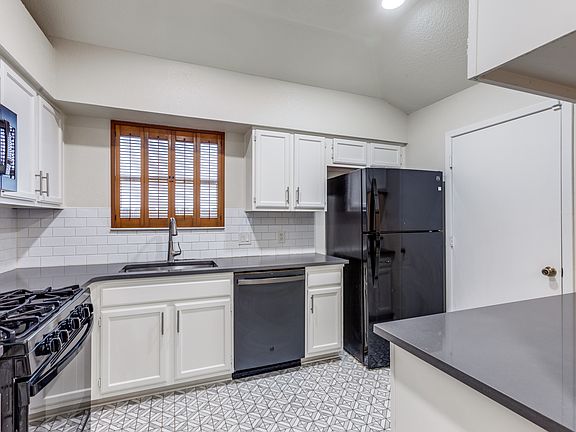 Kitchen with gas stove, new dishwasher and bar area.