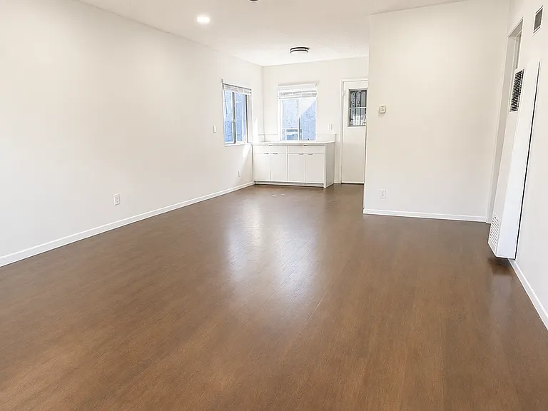 Bright, open living space with recessed lighting, ceiling fan, and room for flexible furniture layouts.