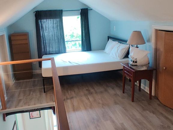Upstairs loft bedroom. Tons of storage on both sides in attic.