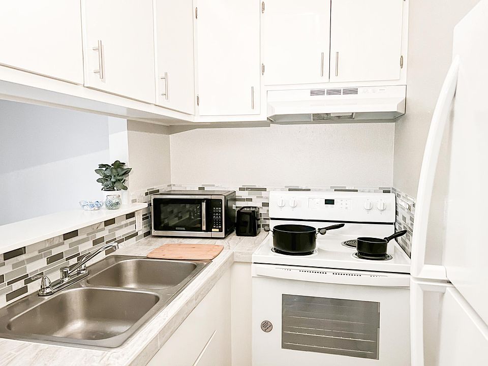 Kitchen comes with new fridge and new stove.