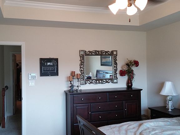 Huge master bedroom with vaulted ceilings and crown molding.