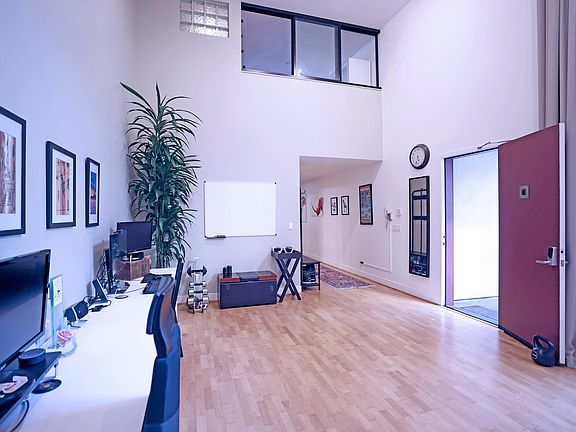 Front door into office. Lofted bedroom can be seen upstairs.