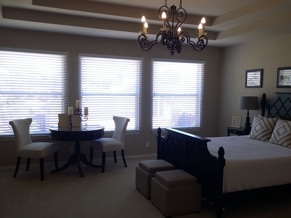 Master bedroom from the doorway, far wall is all windows, wi