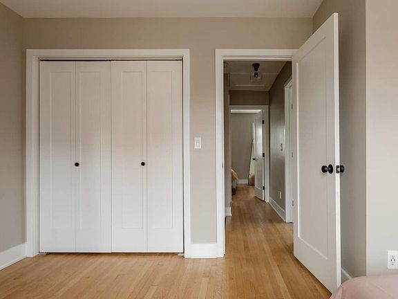 Second level larger bedroom with hall view. Washer and dryer in hall.