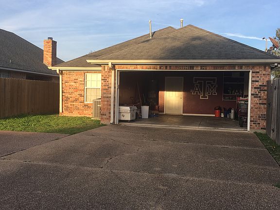 Rear-entry 2-car garage with extra wide alleyway.