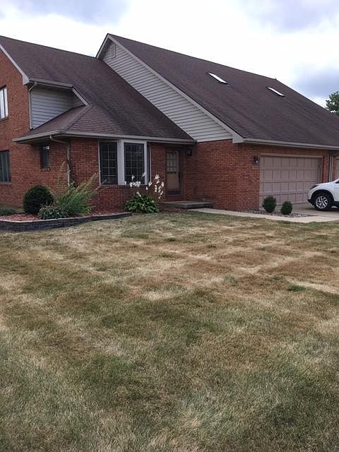 The duplex is fully bricked with Pella windows that have blinds inside the glass. The grass is mowed by a private company and the shrubs around the home should be maintained with little effort.