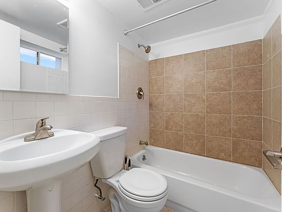 Upgraded full bathroom with tub and shower and ceramic tile walls and floors