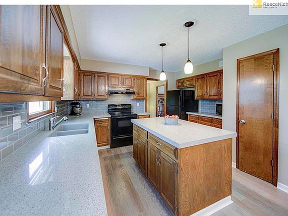 Recently remodeled Kitchen with new hardwoods, Quartz Counters, backsplash and lighting.  Gorgeous!!