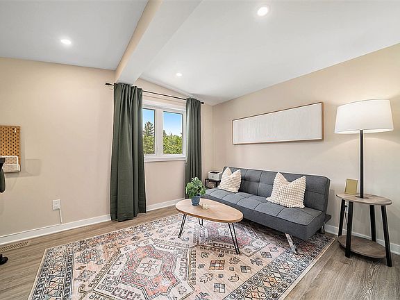 Large den/office in our Ottawa furnished rental, designed for comfort and modern aesthetic.