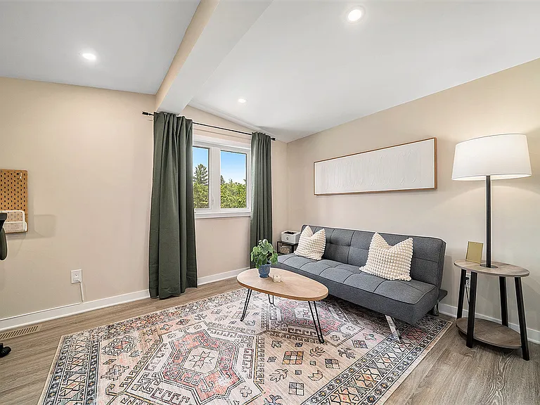 Large den/office in our Ottawa furnished rental, designed for comfort and modern aesthetic.