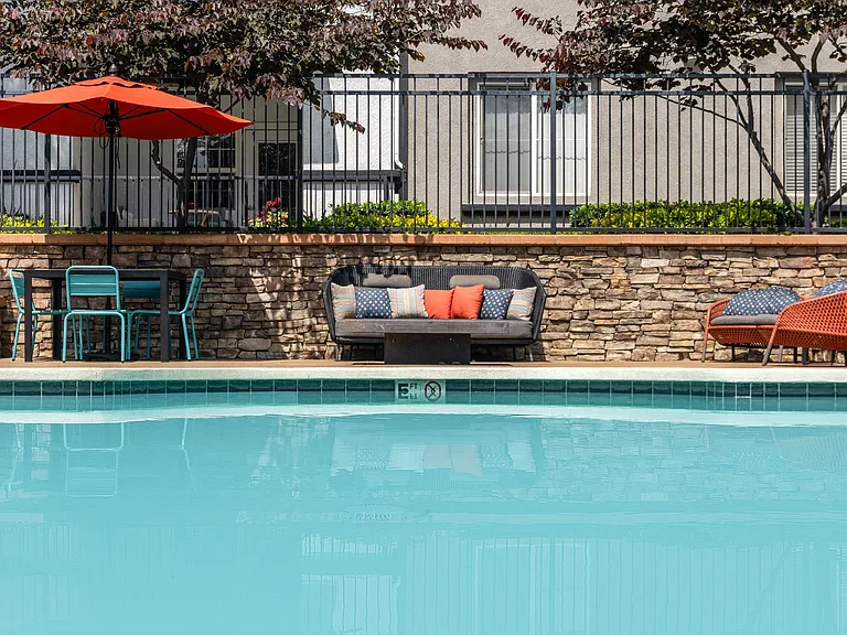 Outdoor Pool Area with Comfortable Couch and Dining Seating