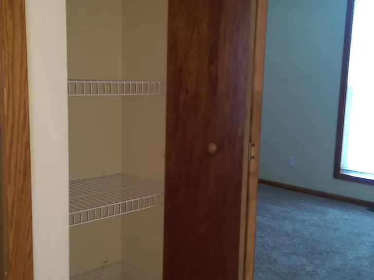 Hall linen closet looking into second bedroom