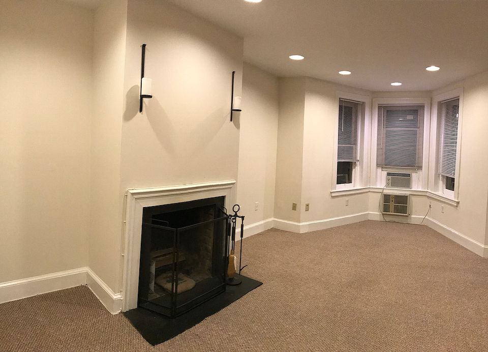 Another view of front room, highlighting fireplace