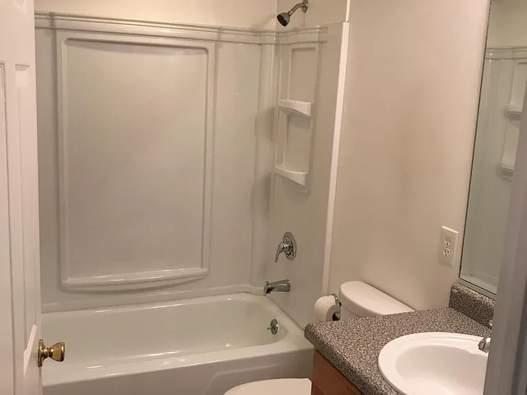 Bathroom in hallway off Bedroom #2 with Bathtub
