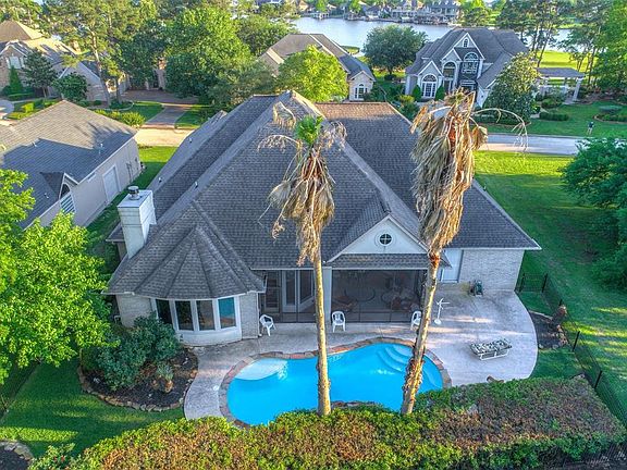 Private backyard boasting of a peaceful screened porch and refreshing pool with waterfall.