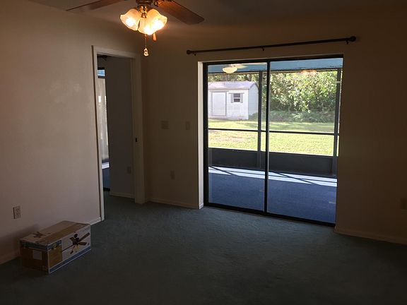 Master Bedroom Looking at Large screen Lanai and Super Private Back Yard. New Fan Installed in box. Home has all new LED Fans and Bulbs.