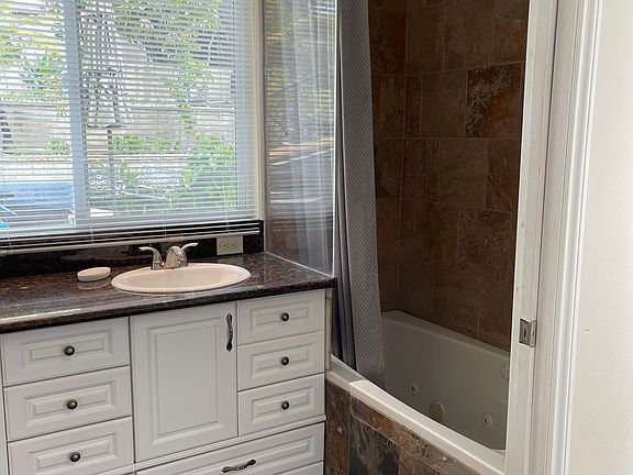 Bath with jacuzzi tub.