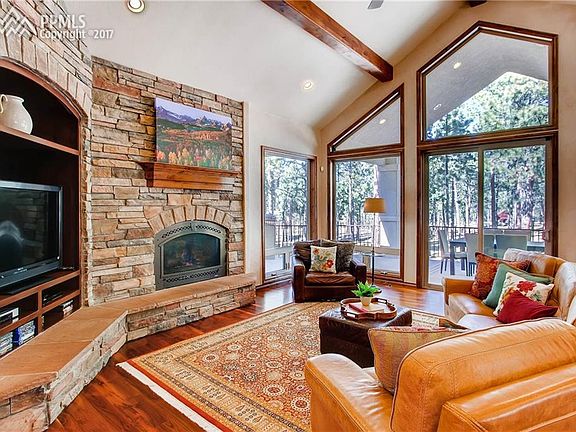 Stunning vaulted and beamed ceilings and stacked stone fireplace