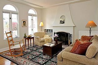 Light and lovely living room with fireplace and hardwood floors
