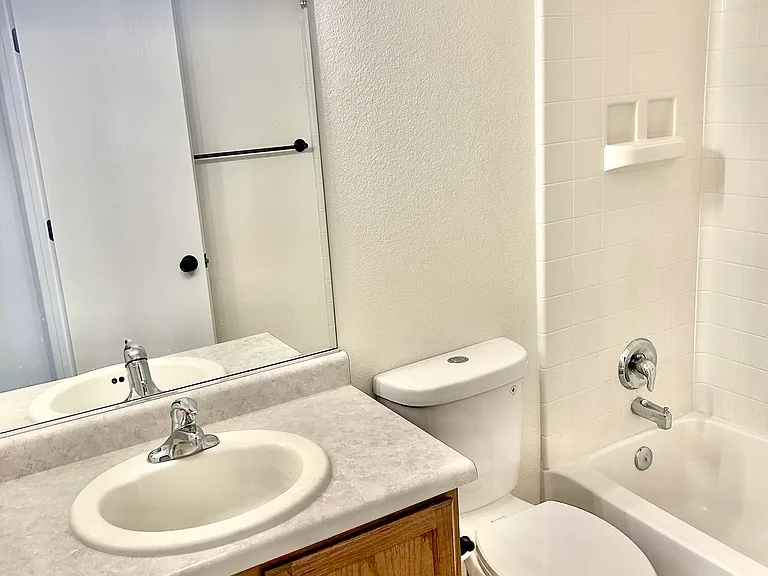Second bathroom is off of living room with bathtub
