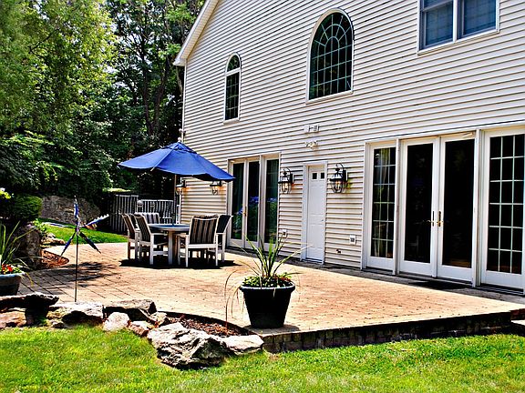 Patio  beside gardens and waterfall on the side of the house