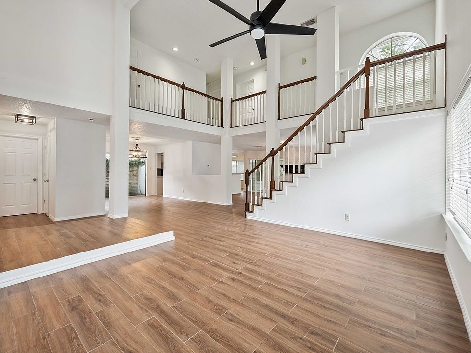 Open-concept living space featuring soaring ceilings and elegant tile floors